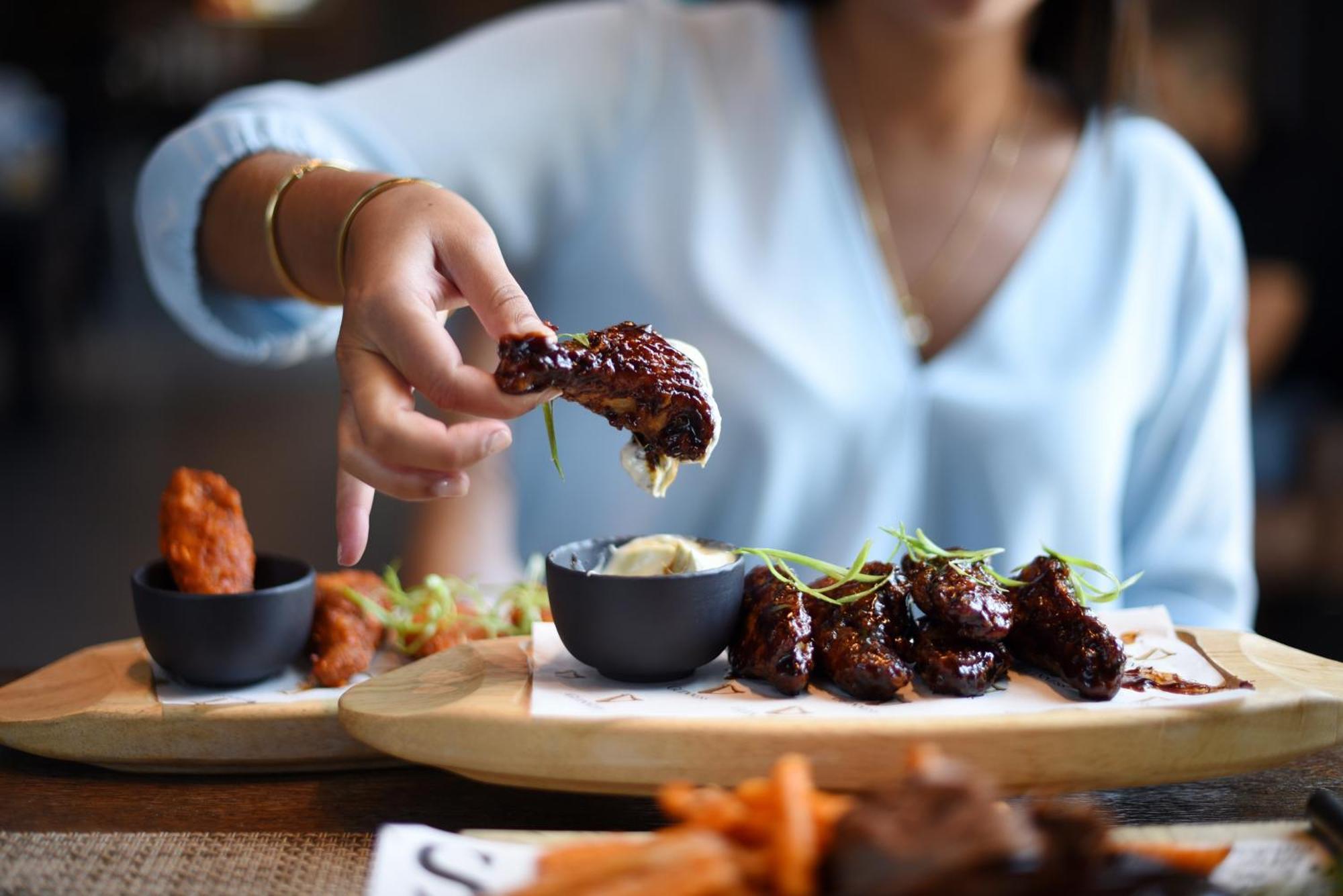 Hilton Dubai Al Habtoor City Exterior photo A woman eating chicken